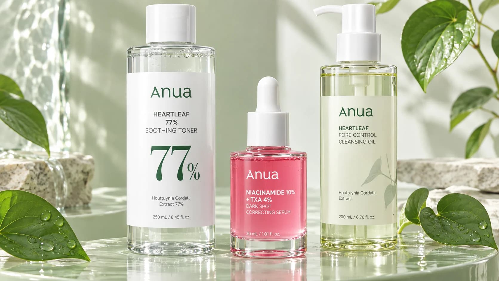 Anua Heartleaf toner, niacinamide serum and cleansing oil on a sage green backdrop